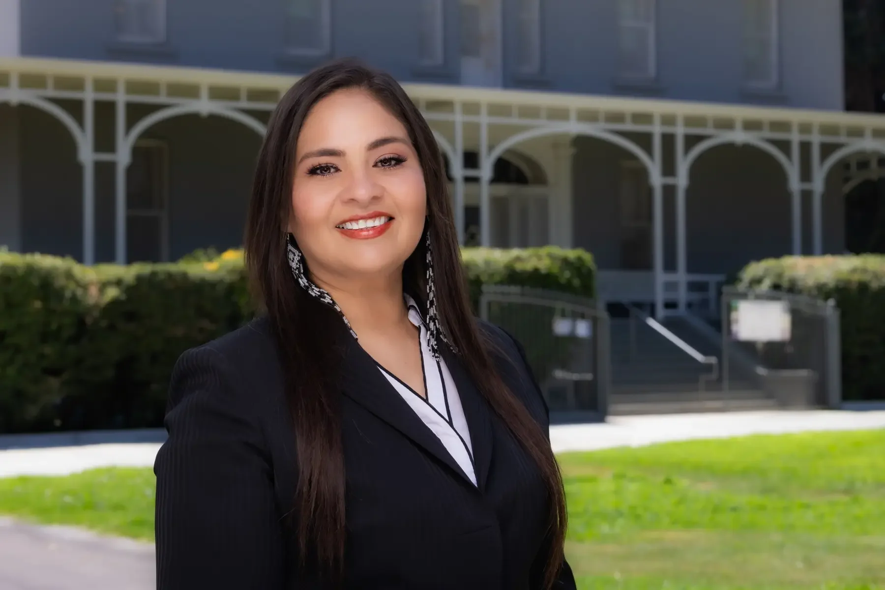Maria Pacheco standing in front of a community building